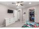 bedroom includes a walk-in closet, mounted tv, and carpeting at 11127 E Tripoli Ave, Mesa, AZ 85212