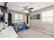 A bedroom featuring light walls, desk area, and a ceiling fan at 11127 E Tripoli Ave, Mesa, AZ 85212