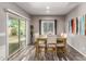 Bright dining room with a sliding glass door, modern decor, hardwood floors, and natural light at 11127 E Tripoli Ave, Mesa, AZ 85212