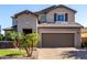 Inviting two-story home with a well-maintained lawn, spacious driveway, and classic architectural details at 11127 E Tripoli Ave, Mesa, AZ 85212