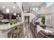 Spacious living room featuring a high ceiling, wrought iron staircase, and open layout flowing into the kitchen area at 11127 E Tripoli Ave, Mesa, AZ 85212