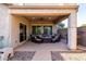 Covered patio area with comfortable seating, perfect for outdoor relaxation and entertaining with a ceiling fan overhead at 11127 E Tripoli Ave, Mesa, AZ 85212