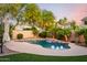 Beautiful backyard pool with lush landscaping, string lights, and a waterfall feature, perfect for relaxation and entertaining at 11127 E Tripoli Ave, Mesa, AZ 85212