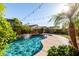 Inviting backyard pool featuring a waterfall feature, lush landscaping, and string lights for evening enjoyment at 11127 E Tripoli Ave, Mesa, AZ 85212