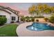 Backyard pool featuring a unique shape, water features, lush landscaping, and an outdoor living space at 11127 E Tripoli Ave, Mesa, AZ 85212