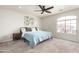 Bright bedroom with a large window, comfortable bed, and ceiling fan at 11473 W Austin Thomas Dr, Surprise, AZ 85378