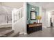 Inviting entryway featuring stairs, tiled floor, and stylish console table with a mirror at 11473 W Austin Thomas Dr, Surprise, AZ 85378