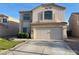 Charming two-story home showcasing a well-maintained front yard and a spacious two-car garage at 11473 W Austin Thomas Dr, Surprise, AZ 85378