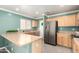 Well-equipped kitchen with stainless steel appliances and neutral countertops at 11473 W Austin Thomas Dr, Surprise, AZ 85378