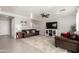 Spacious living room featuring tile floors, comfortable seating, and a ceiling fan at 11473 W Austin Thomas Dr, Surprise, AZ 85378