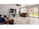 Cozy living room with sliding glass doors, tile floors, and modern furnishings at 11473 W Austin Thomas Dr, Surprise, AZ 85378