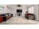Comfortable living room with tile floors, ceiling fan, and staircase access at 11473 W Austin Thomas Dr, Surprise, AZ 85378