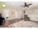 Upstairs living room featuring hardwood floors, a ceiling fan, natural light, and a comfortable recliner at 11473 W Austin Thomas Dr, Surprise, AZ 85378