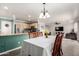 Open floor plan showcasing the kitchen, dining area, and living room with stylish furnishings at 11473 W Austin Thomas Dr, Surprise, AZ 85378
