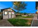 Charming backyard with a cute shed, string lights, a tree, and brick pathway at 11530 E Vine Ave, Mesa, AZ 85208