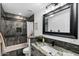 Stylish bathroom with dark tile shower, modern vanity, decorative mirror, and mosaic backsplash at 11530 E Vine Ave, Mesa, AZ 85208