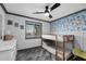Cozy bedroom with bunk beds, a ceiling fan, gray trim, and fun floral wallpaper at 11530 E Vine Ave, Mesa, AZ 85208