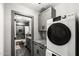 Well-lit laundry room with gray cabinets, a dark countertop, and a washer and dryer set at 11530 E Vine Ave, Mesa, AZ 85208