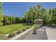 Expansive backyard featuring well-maintained artificial turf, landscaped garden beds, and mature trees at 11675 E Caron St, Scottsdale, AZ 85259