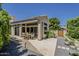 Exterior view of home featuring a large outdoor patio area, well-maintained landscaping, and attractive hardscaping at 11675 E Caron St, Scottsdale, AZ 85259