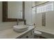 Stylishly designed bathroom featuring a vessel sink, decorative mirror, and a tiled shower/tub combination at 11675 E Caron St, Scottsdale, AZ 85259