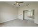 Bright bedroom with a neutral color palette, carpet flooring, ceiling fan and access to another room at 11675 E Caron St, Scottsdale, AZ 85259