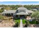 Striking aerial view of the community clubhouse with elegant water feature and meticulously manicured landscaping at 11675 E Caron St, Scottsdale, AZ 85259