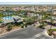 High aerial view of community clubhouse, swimming pool, tennis courts, and American flag on a sunny day at 11675 E Caron St, Scottsdale, AZ 85259