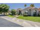 Charming home exterior features a well-maintained lawn, mature trees and inviting curb appeal at 11675 E Caron St, Scottsdale, AZ 85259