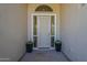 Elegant front door with sidelights and decorative planters provides a welcoming entrance at 11675 E Caron St, Scottsdale, AZ 85259