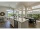 Bright and open kitchen featuring a large island, modern appliances, and expansive windows at 11675 E Caron St, Scottsdale, AZ 85259