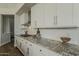 Granite counters and white cabinets are shown in this well-appointed kitchen at 11675 E Caron St, Scottsdale, AZ 85259