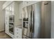 Stainless steel refrigerator and built-in oven are featured in this modern kitchen at 11675 E Caron St, Scottsdale, AZ 85259