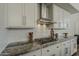 Detailed view of the kitchen showcases a gas cooktop and custom backsplash at 11675 E Caron St, Scottsdale, AZ 85259