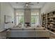 Bright living room with fireplace, high ceilings, and large windows bringing the outside in at 11675 E Caron St, Scottsdale, AZ 85259