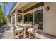 Inviting covered outdoor patio features a dining table with seating and views through large sliding glass doors at 11675 E Caron St, Scottsdale, AZ 85259