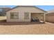 Home back exterior showcasing a patio and gravel landscaping for easy upkeep at 12416 W Midway Ave, Glendale, AZ 85307