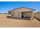 Exterior view of the home featuring a covered patio and low-maintenance yard at 12416 W Midway Ave, Glendale, AZ 85307