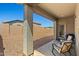 Covered back patio with seating overlooking a low-maintenance backyard at 12416 W Midway Ave, Glendale, AZ 85307