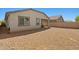 Spacious backyard featuring desert landscaping and a covered patio, perfect for outdoor relaxation and entertaining at 12416 W Midway Ave, Glendale, AZ 85307