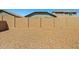 Walled-in backyard with gravel cover and desert landscaping ensures privacy and low maintenance in a Gathering community at 12416 W Midway Ave, Glendale, AZ 85307
