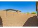 Large backyard with gravel ground cover, enclosed by block wall fencing for privacy at 12416 W Midway Ave, Glendale, AZ 85307