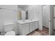 Bathroom with a double sink vanity, a large mirror, and a shower-tub combination with wood-look flooring at 12416 W Midway Ave, Glendale, AZ 85307