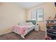 Cozy bedroom featuring a double bed with bright blankets, carpeted flooring, and closet space at 12416 W Midway Ave, Glendale, AZ 85307