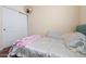 Bedroom with a bed, bright blankets, carpeted floors, and ample space for storage at 12416 W Midway Ave, Glendale, AZ 85307