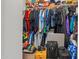 Walk-in closet providing ample storage with clothing, shoes, and luggage racks at 12416 W Midway Ave, Glendale, AZ 85307