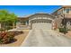 Single-story home with desert landscaping, basketball hoop, and a two-car garage at 12416 W Midway Ave, Glendale, AZ 85307