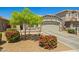 Well-maintained single-story home features desert landscaping, a two-car garage and a basketball hoop at 12416 W Midway Ave, Glendale, AZ 85307