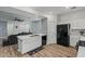 Well-designed kitchen featuring a sink, black dishwasher, and ample countertop space with a glimpse of the living room at 12416 W Midway Ave, Glendale, AZ 85307