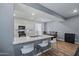 Eat-in kitchen with white cabinets, breakfast bar and stainless appliances at 12416 W Midway Ave, Glendale, AZ 85307